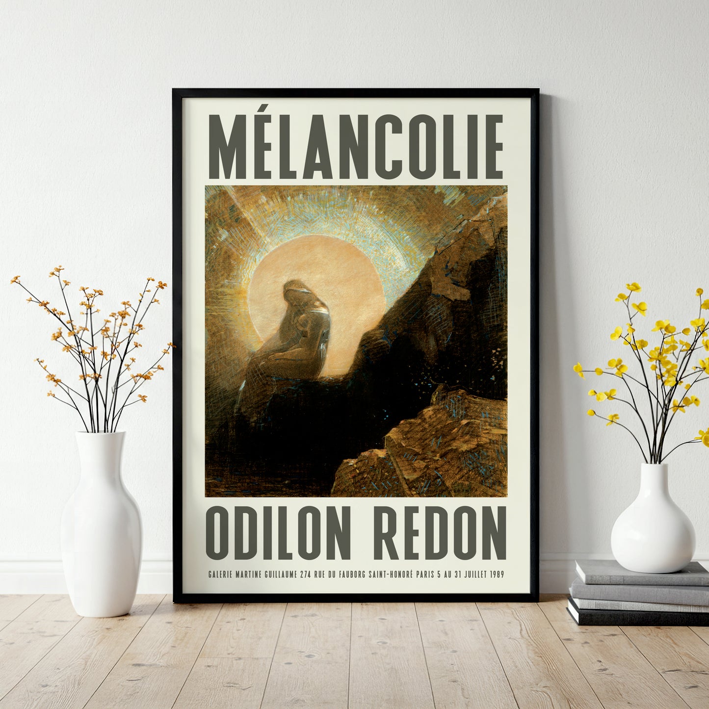 Poster of 'Melancolie' by Odilon Redon in a frame on a wall with decorative vases.