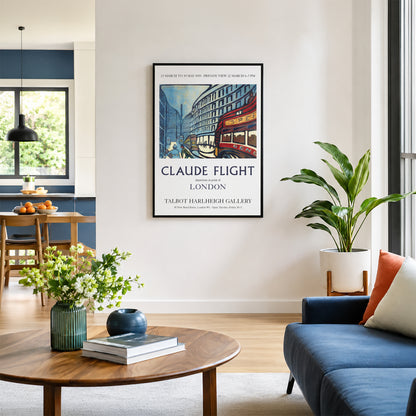 A framed vintage-style travel poster reading 'Claude Flight' hangs on a white wall in a modern living room with a blue sofa, wooden coffee table, and potted plant.