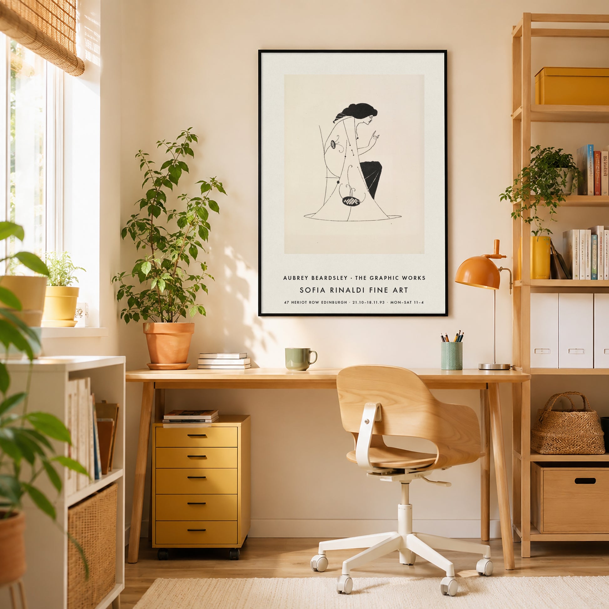 Framed Aubrey Beardsley 'Seated Lady' poster on the wall of a sunlit home office with desk and plants