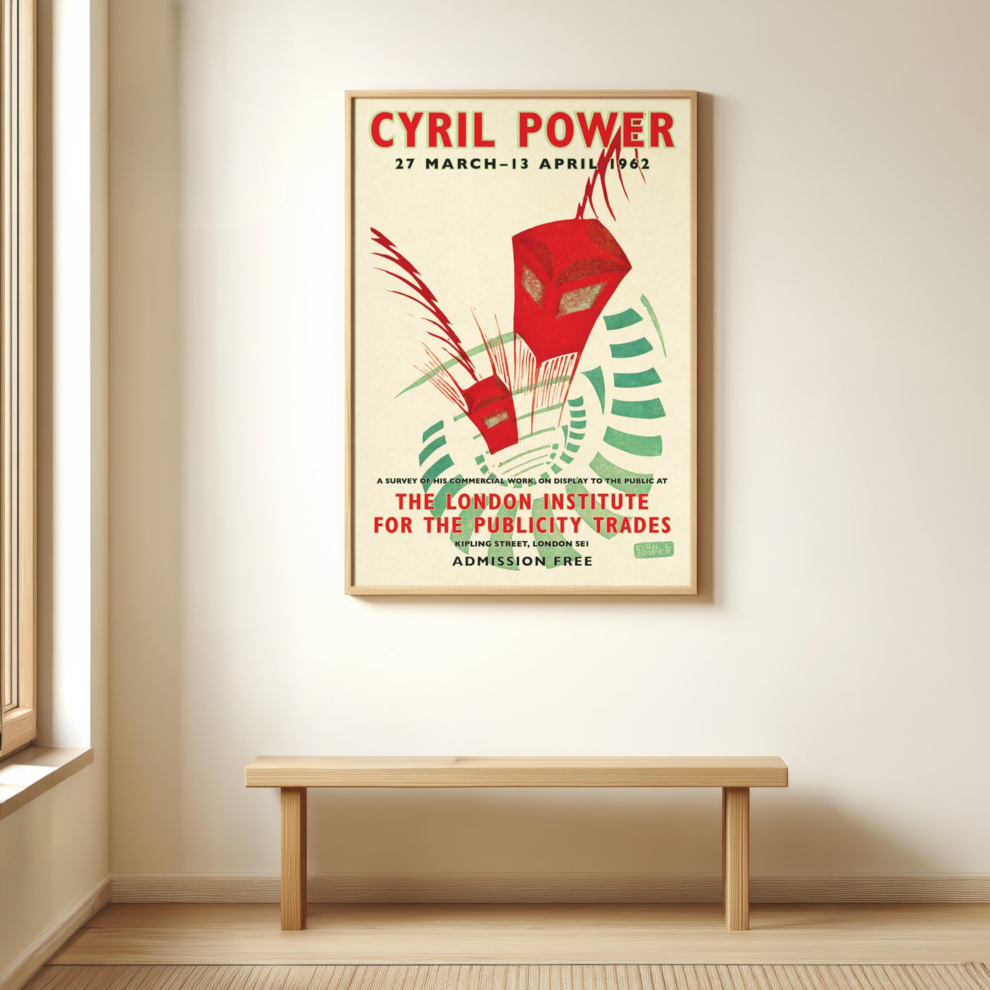 Framed poster of Cyril Power event on a wall above a wooden bench.