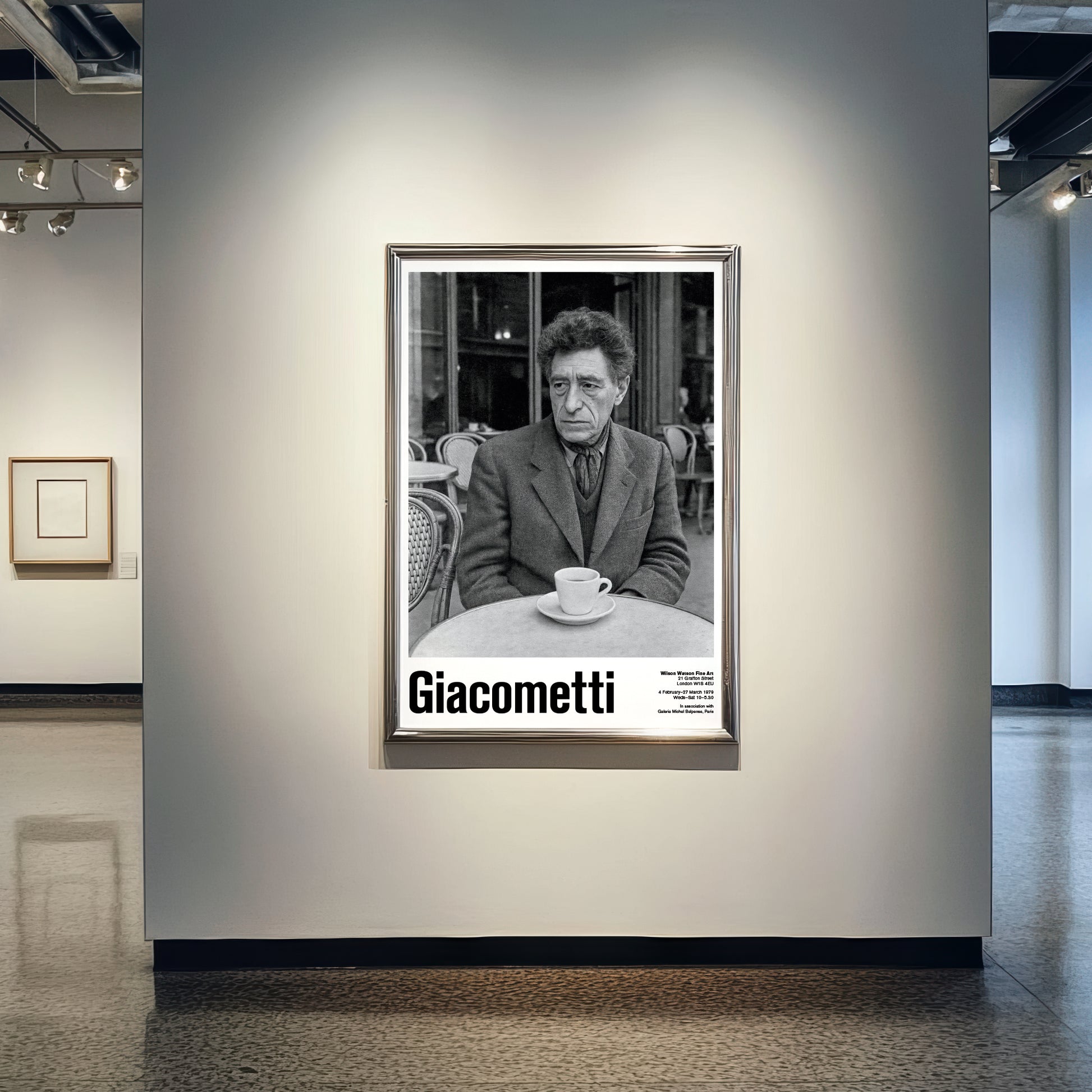 Framed black and white portrait of a man with 'Giacometti' text in an art gallery setting.