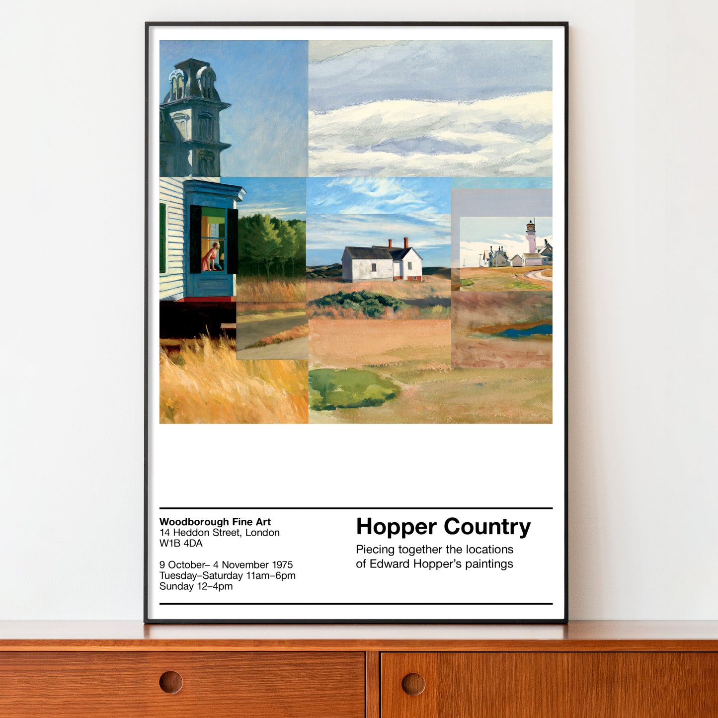 Framed artwork of a landscape with a lighthouse and houses, displayed on a wooden shelf.