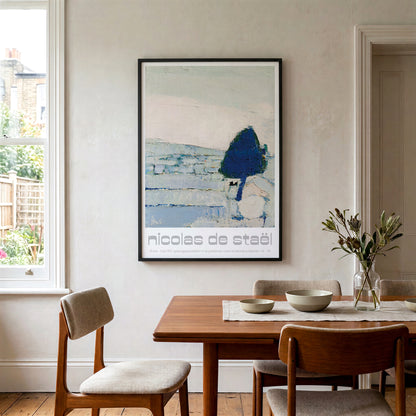 A framed art print by Nicolas de Steèh hanging on a light beige wall in a dining room setting with a wooden table and chairs.